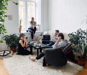 group of people lounging in the living room of an apartment